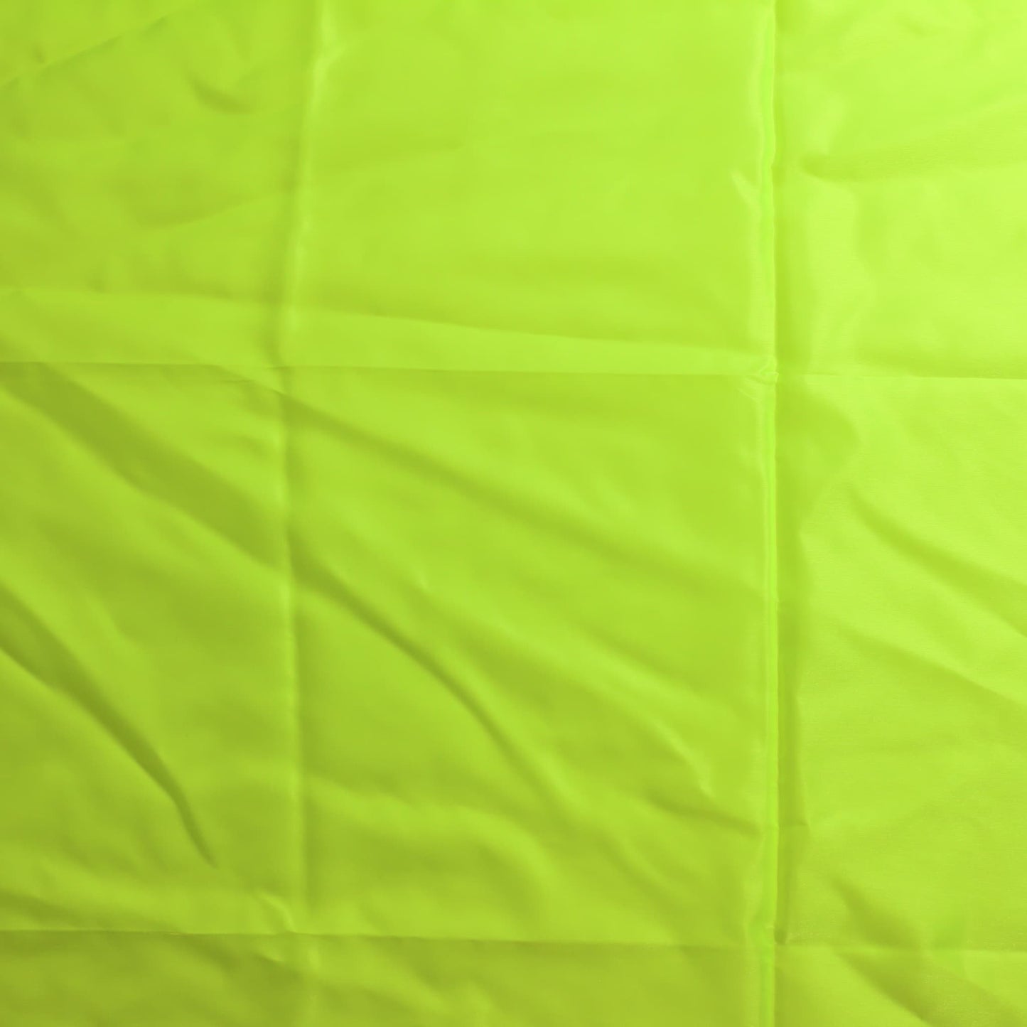 Fluoro yellow nylon taffeta sewing fabric laid flat