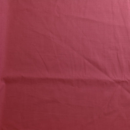 Dusky pink poly-cotton sewing fabric laid flat