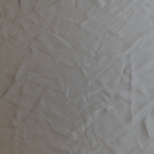 Steel gray polyester satin sewing fabric laid flat