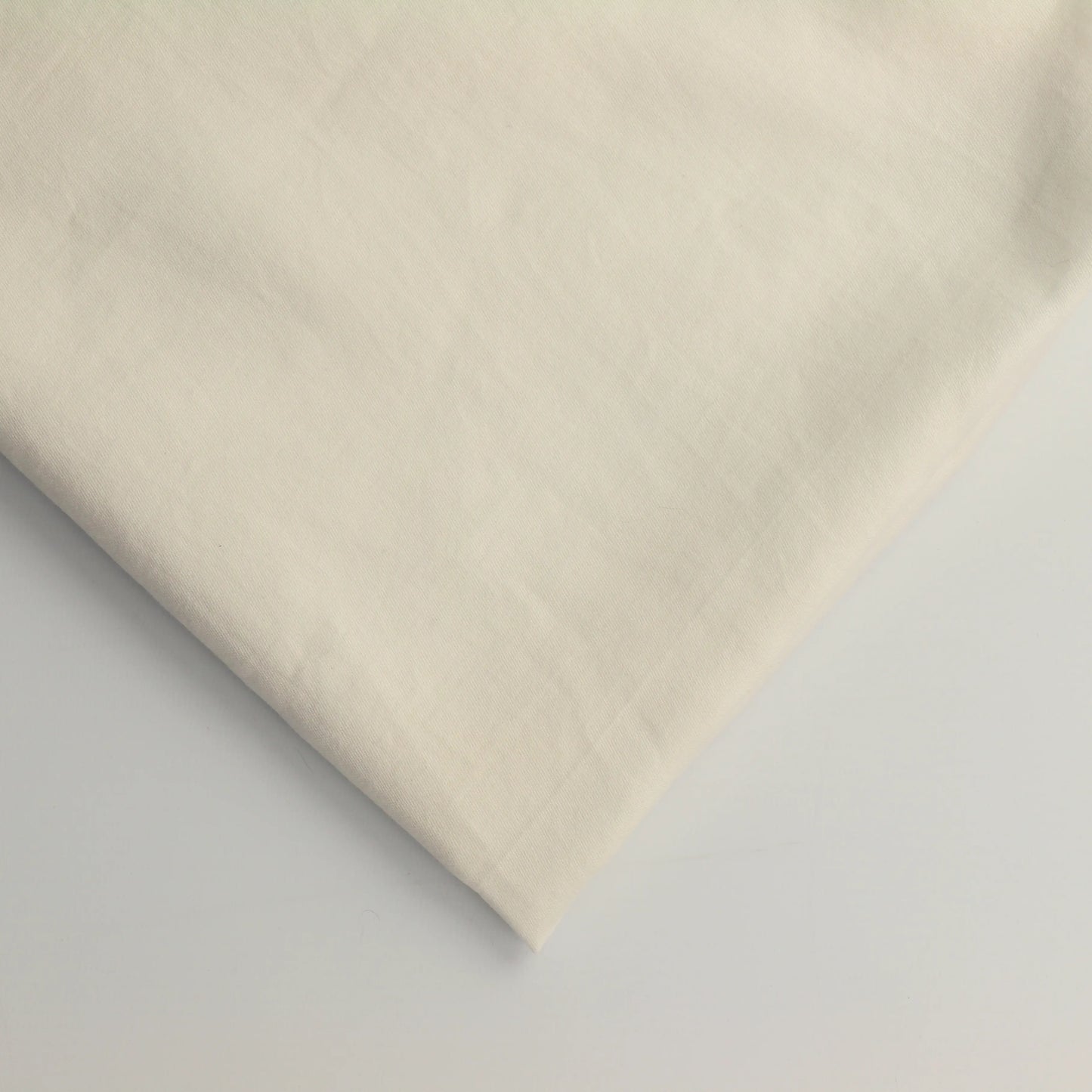 off-white-cotton-sateen-fabric – close-up of colour, pattern and texture