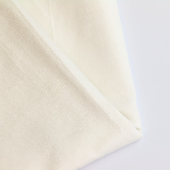 Off-white Cotton Sateen Fabric folded showing detail