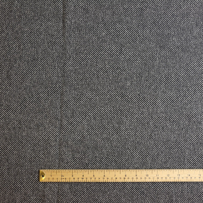 Black and white wool polyester tweed coating fabric laid flat
