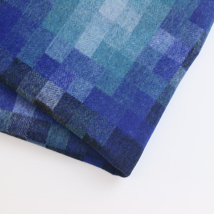 Blue ombre square pattern wool blend coat fabric folded showing detail