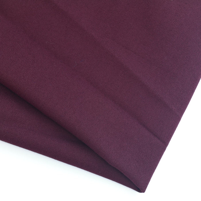 Burgundy polyester viscose twill fabric folded showing texture