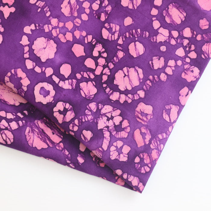 Purple and pink batik cotton fabric folded showing detail