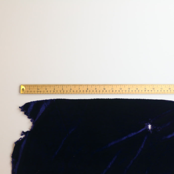 Deep purple crushed velvet fabric laid flat