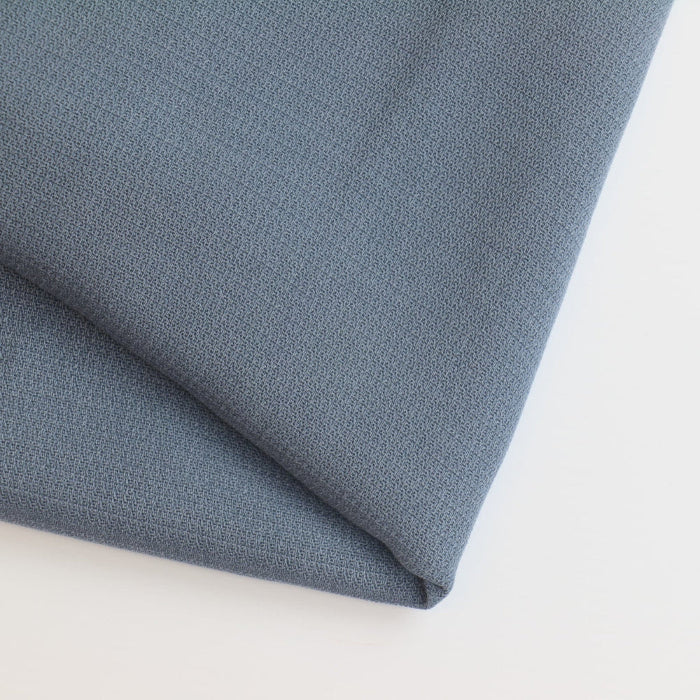 Grey blue viscose twill fabric folded showing detail