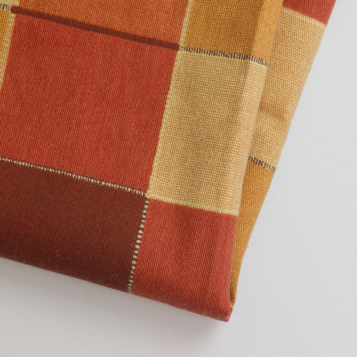 Red orange & gold checked cotton home decor fabric folded showing detail