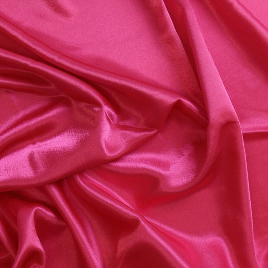 Bright pink polyester satin fabric showing drape