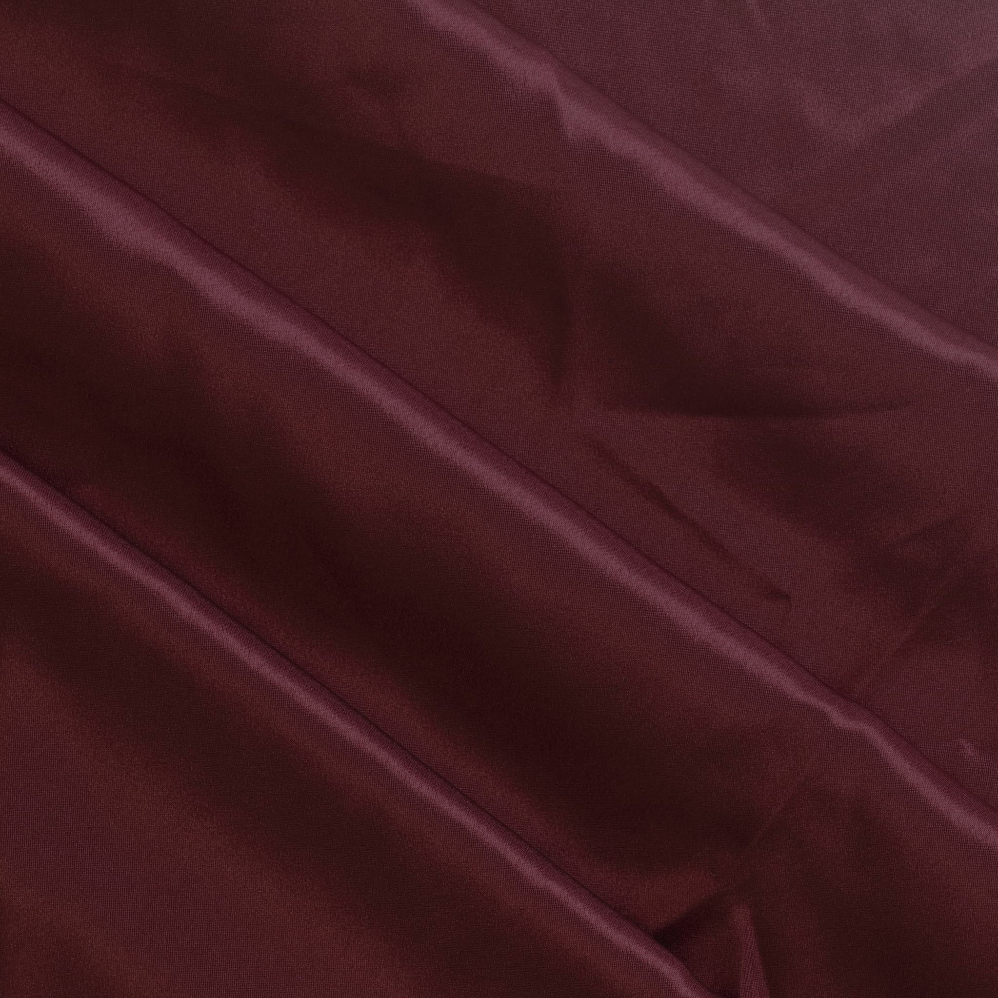 Wine red polyester satin fabric gently folded