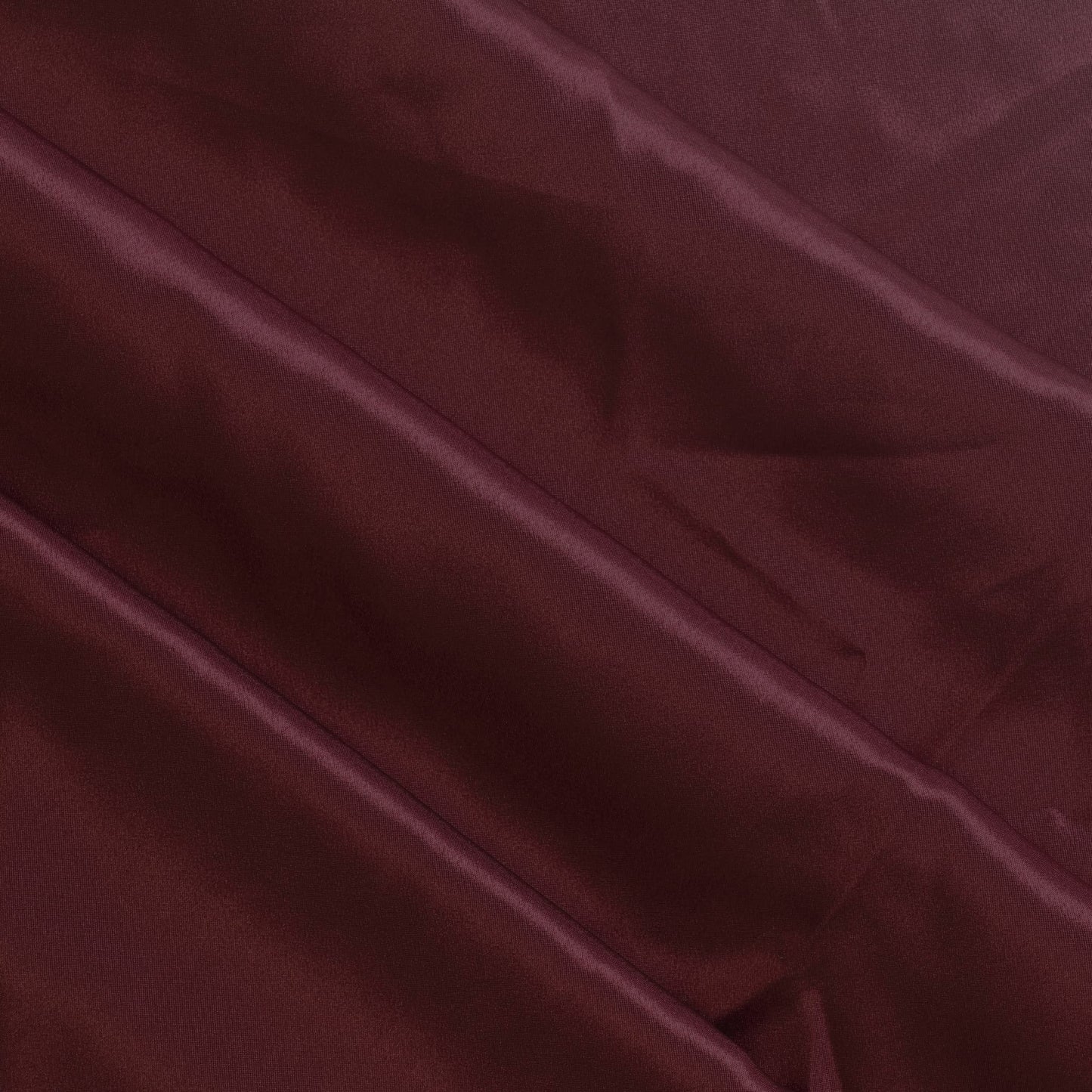 Wine red polyester satin fabric gently folded