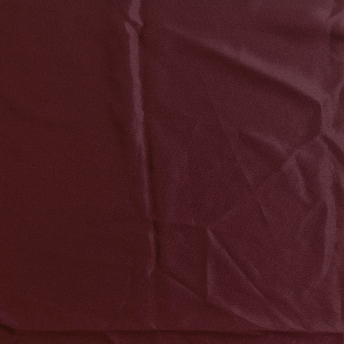 Wine red polyester satin fabric laid flat