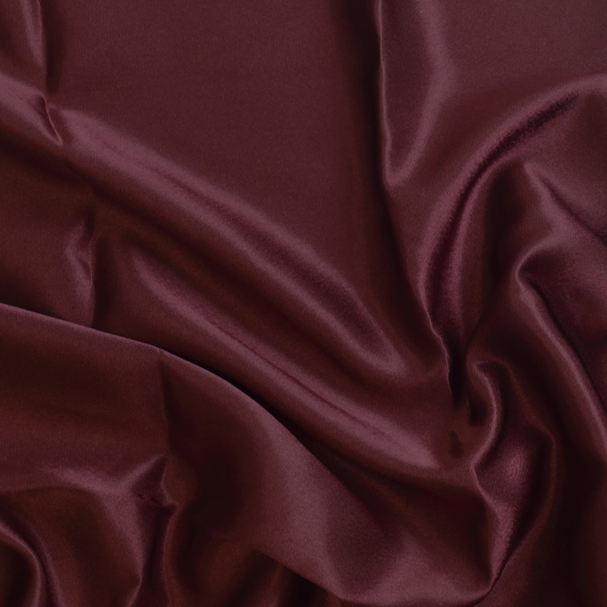 Wine red polyester satin fabric showing drape and sheen