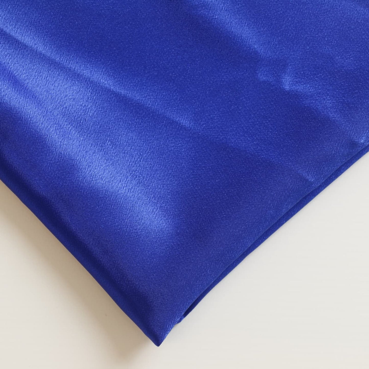Bright blue polyester satin fabric close up
