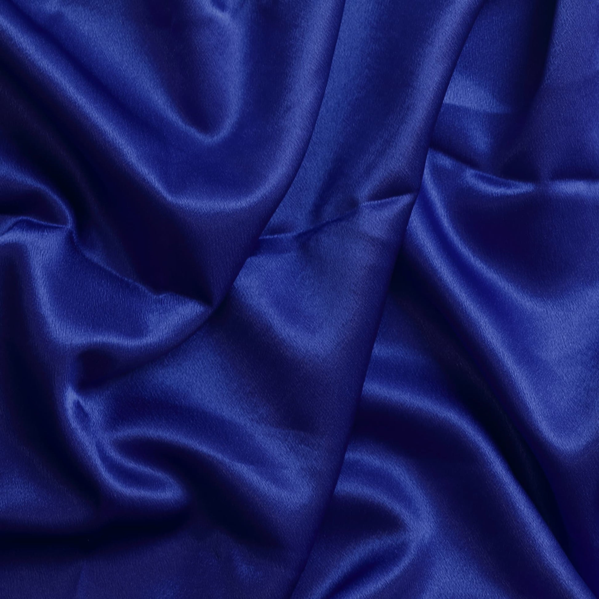 Bright blue polyester satin fabric showing drape