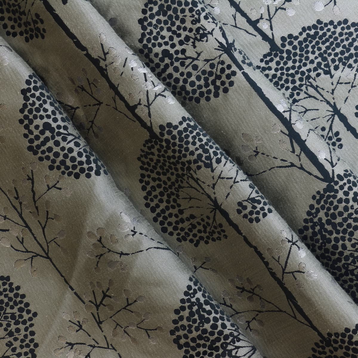 Beige & black tree print jacquard fabric gently folded