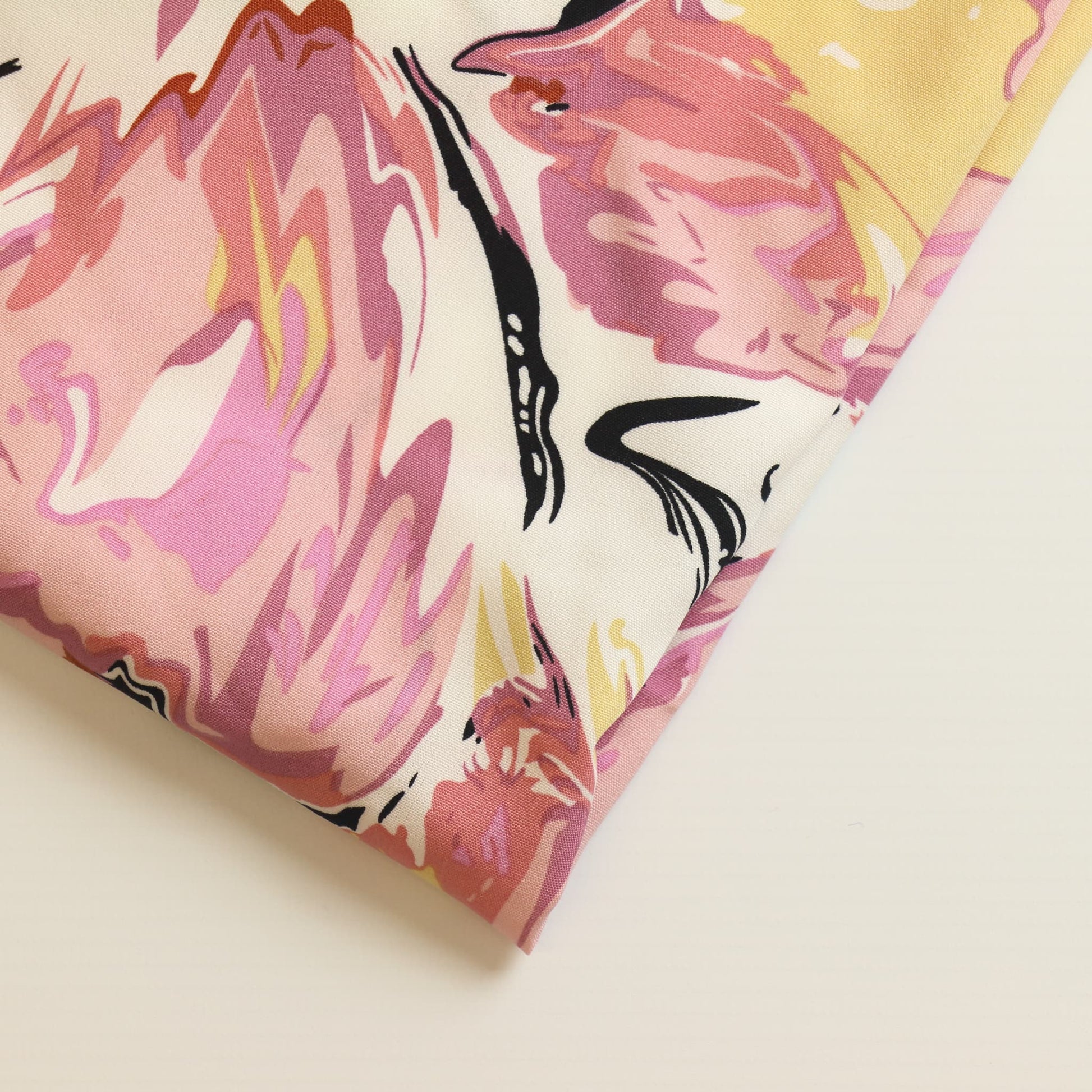 Off-white pink & black graphic print fabric close up