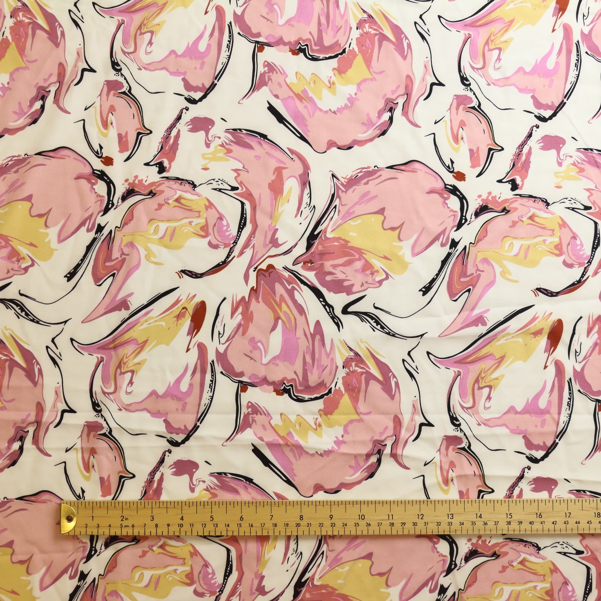 Off-white pink & black graphic print fabric laid flat