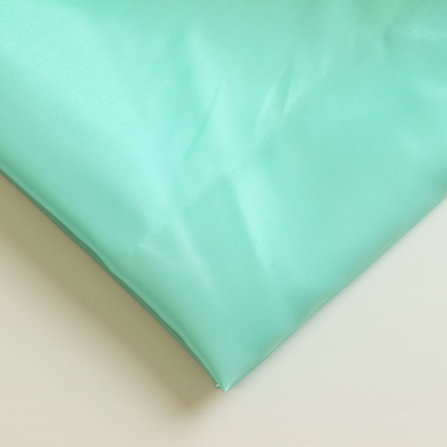Turquoise nylon satin fabric close up