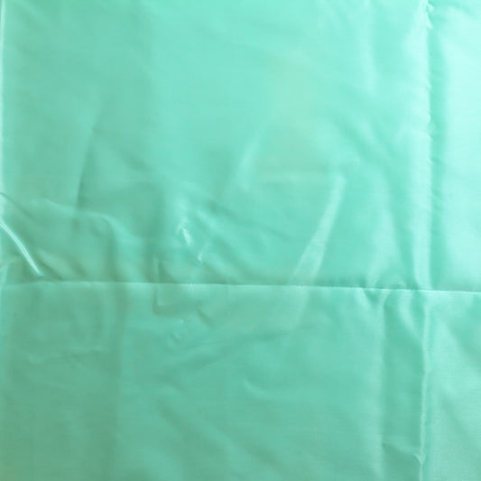 Turquoise nylon satin fabric laid flat