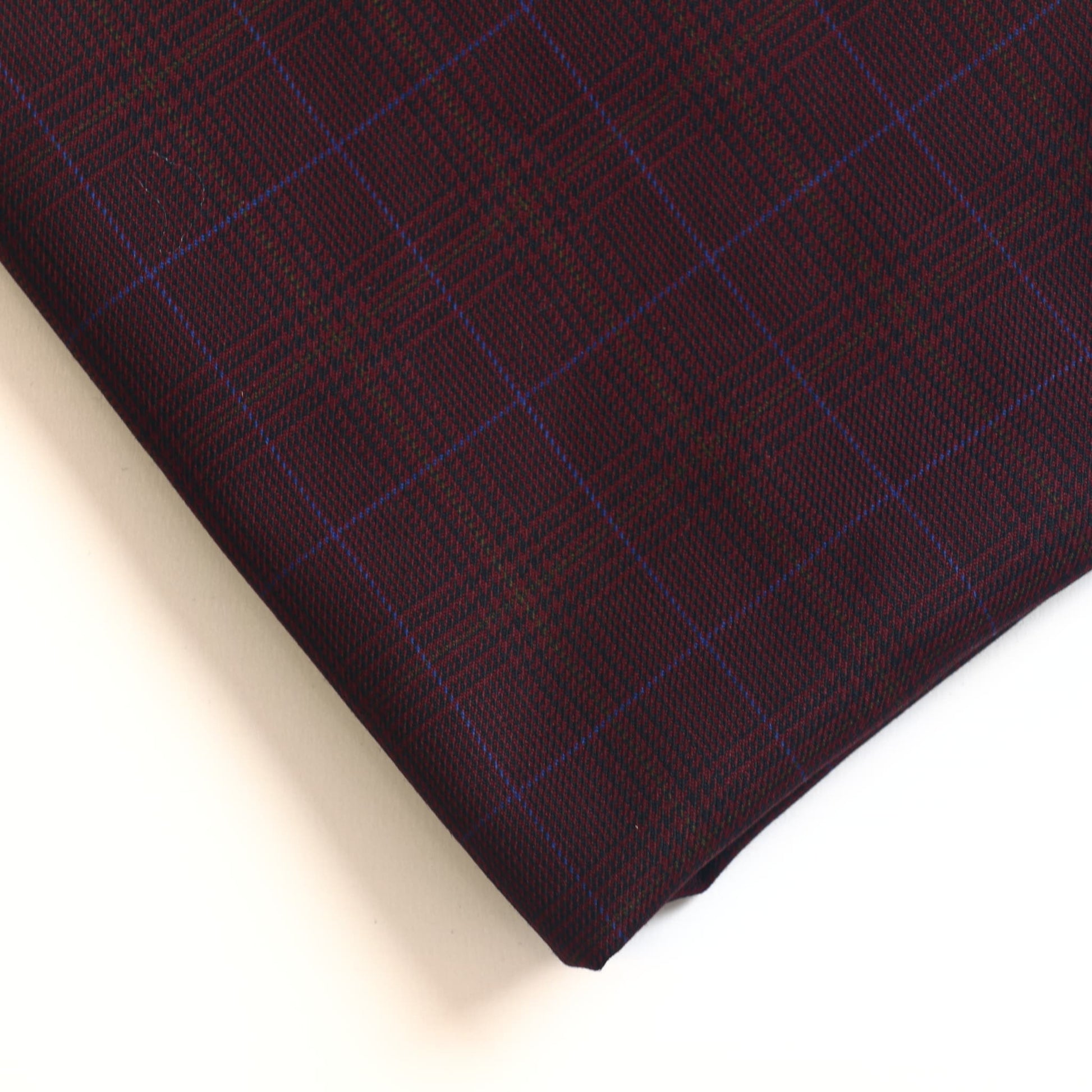 Dark red viscose polyester tartan suiting fabric close up