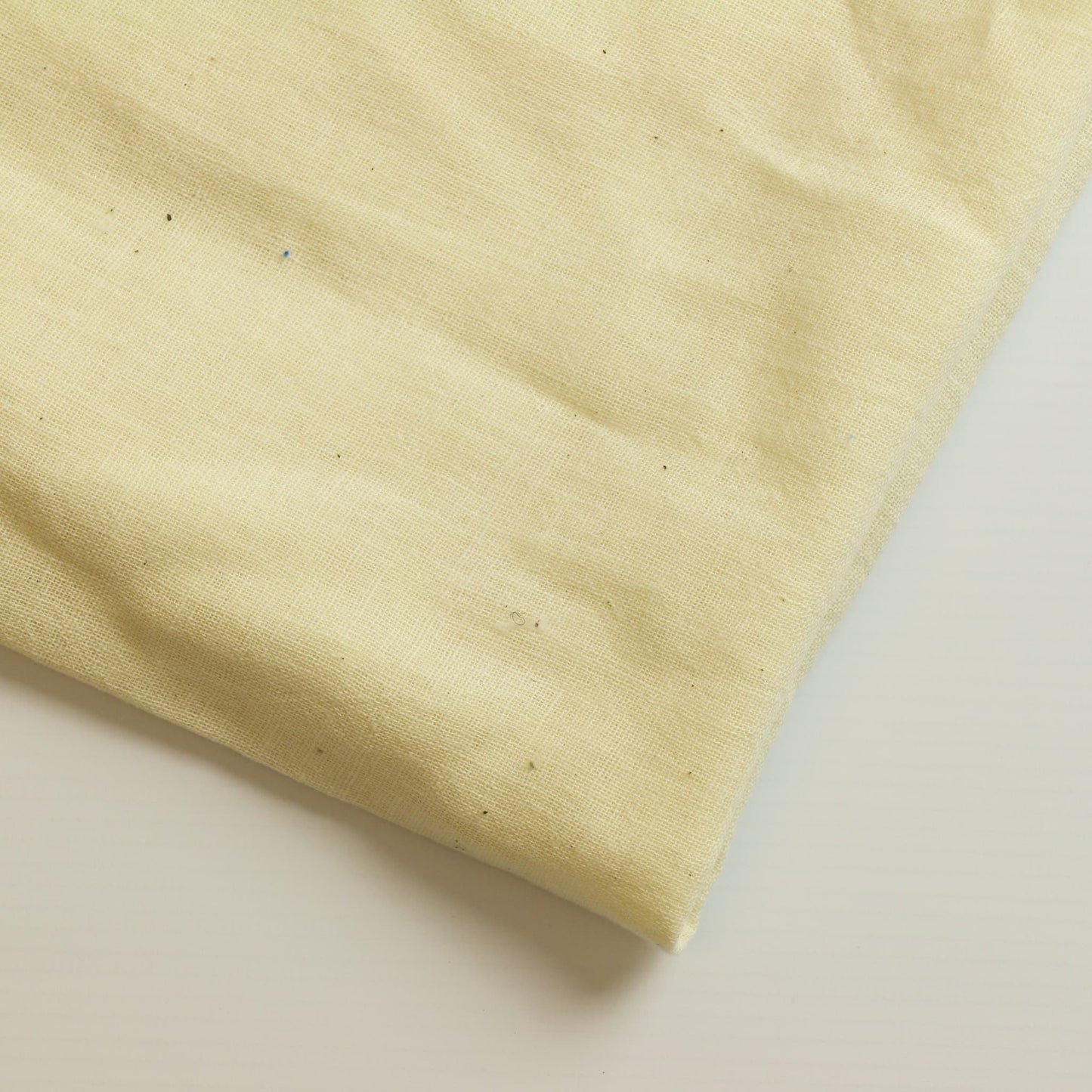 Cream butter muslin sewing fabric close up 