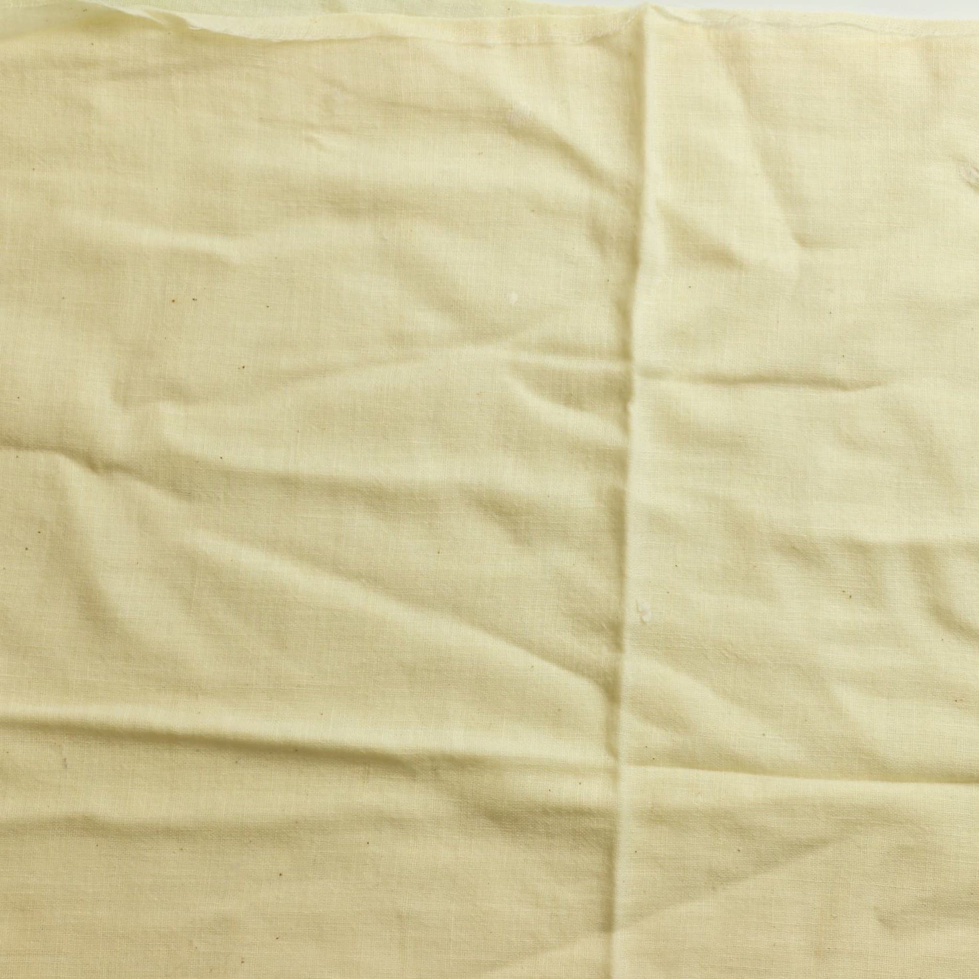 Cream butter muslin sewing fabric laid flat