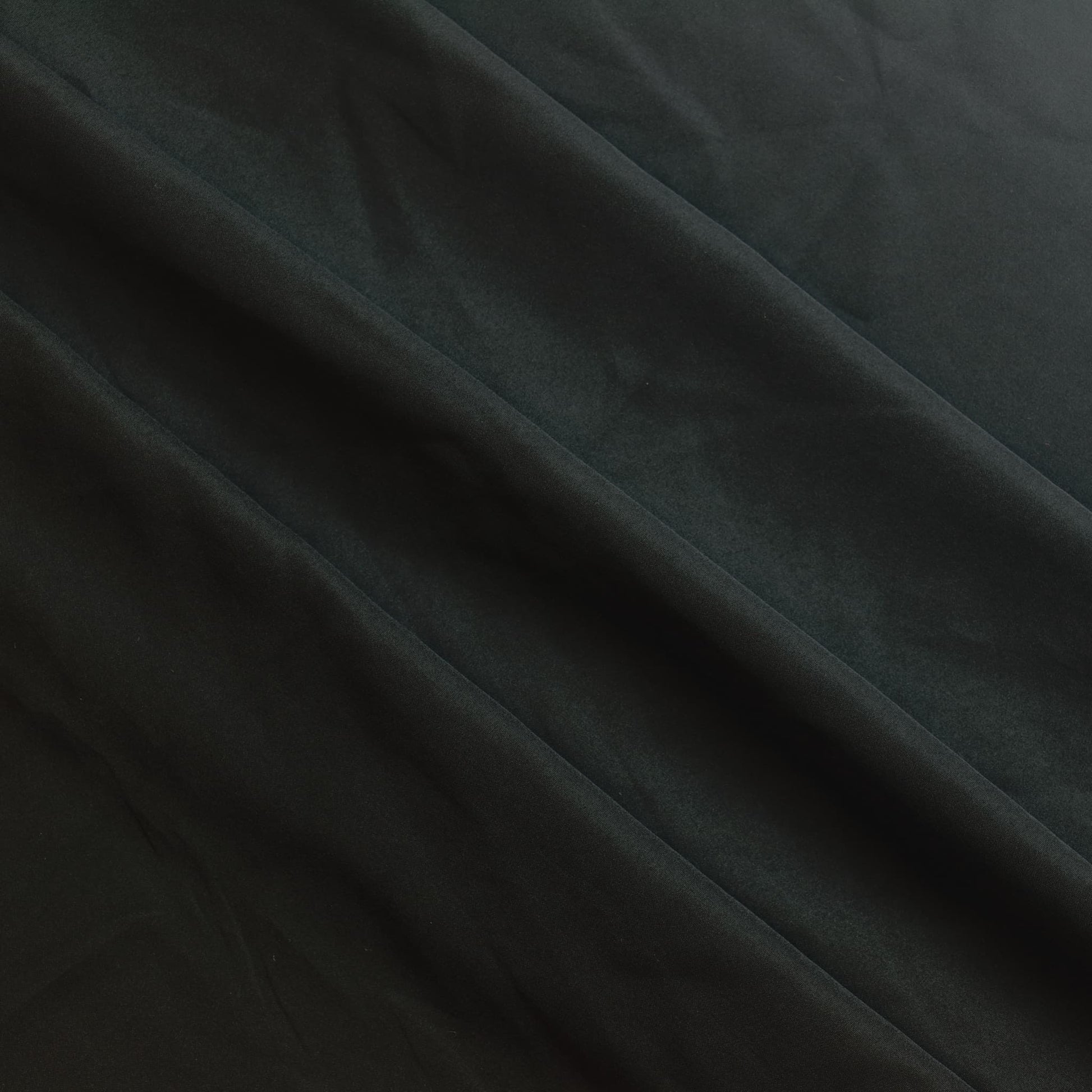 Black polyester sewing fabric gently folded