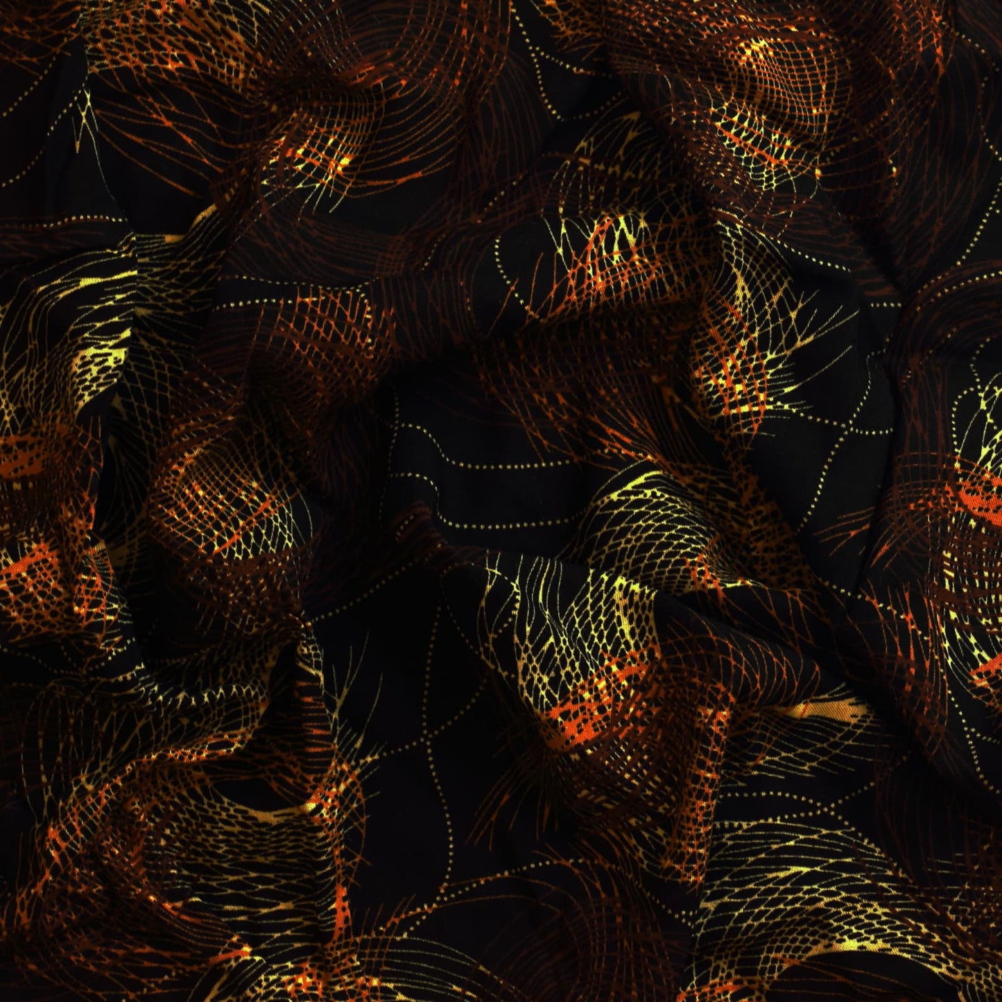Black & gold graphic print viscose twill sewing fabric showing drape