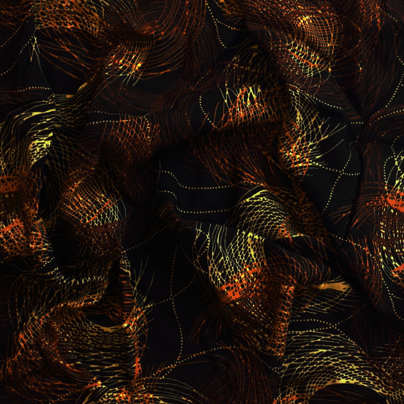 Black & gold graphic print viscose twill sewing fabric showing drape