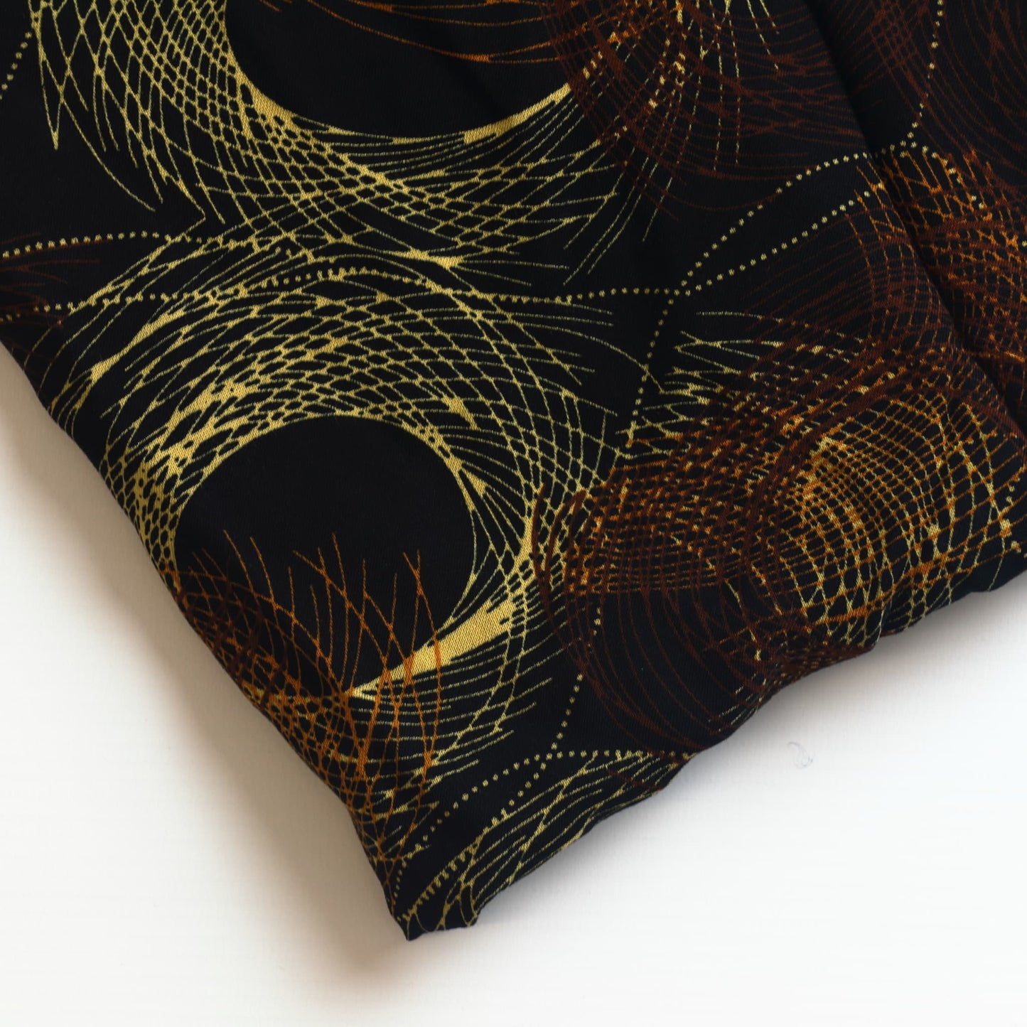 Black & gold graphic print viscose twill sewing fabric close up