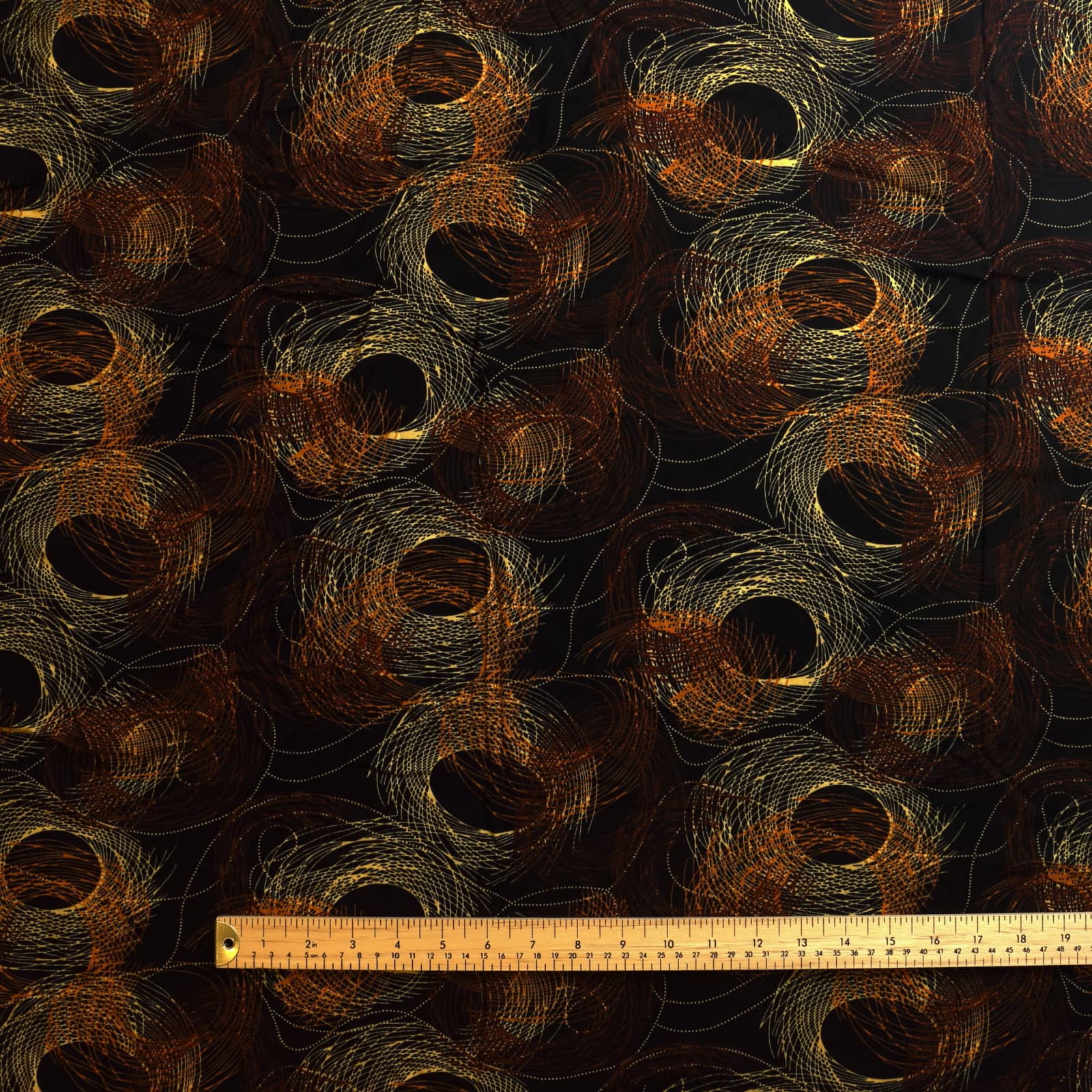 Black & gold graphic print viscose twill sewing fabric laid flat