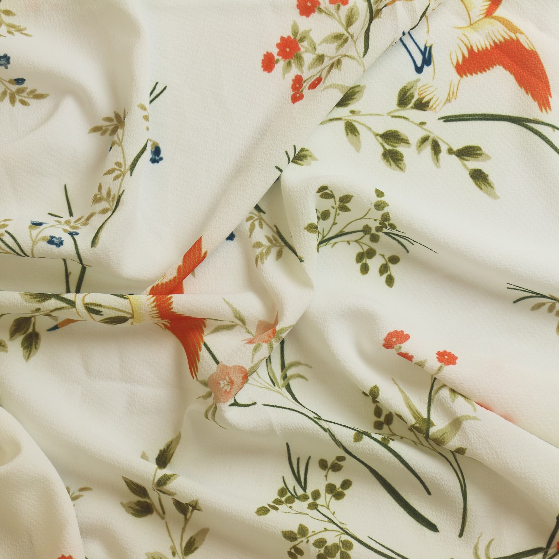 White floral crane print polyester sewing fabric showing drape