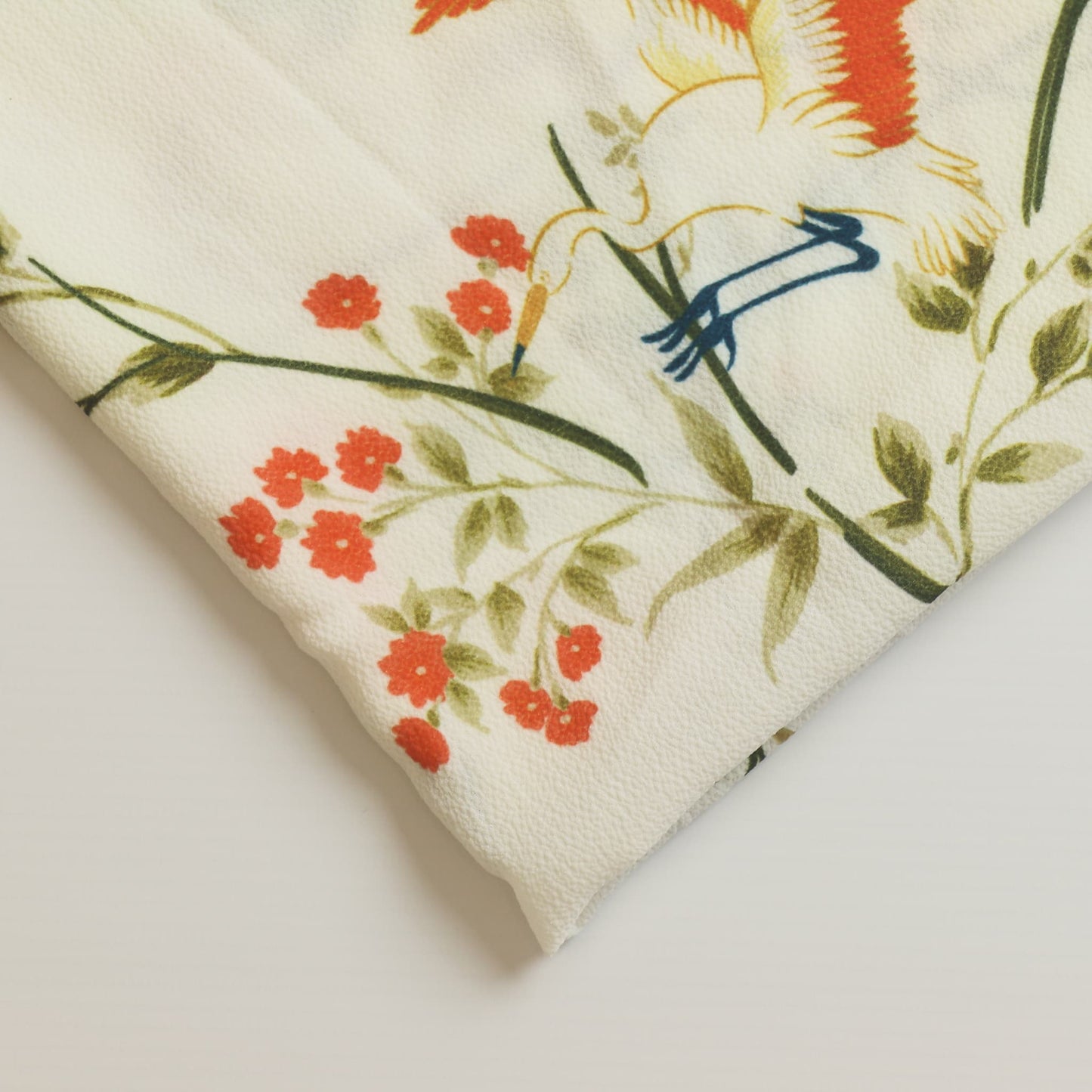 White floral crane print polyester sewing fabric close up