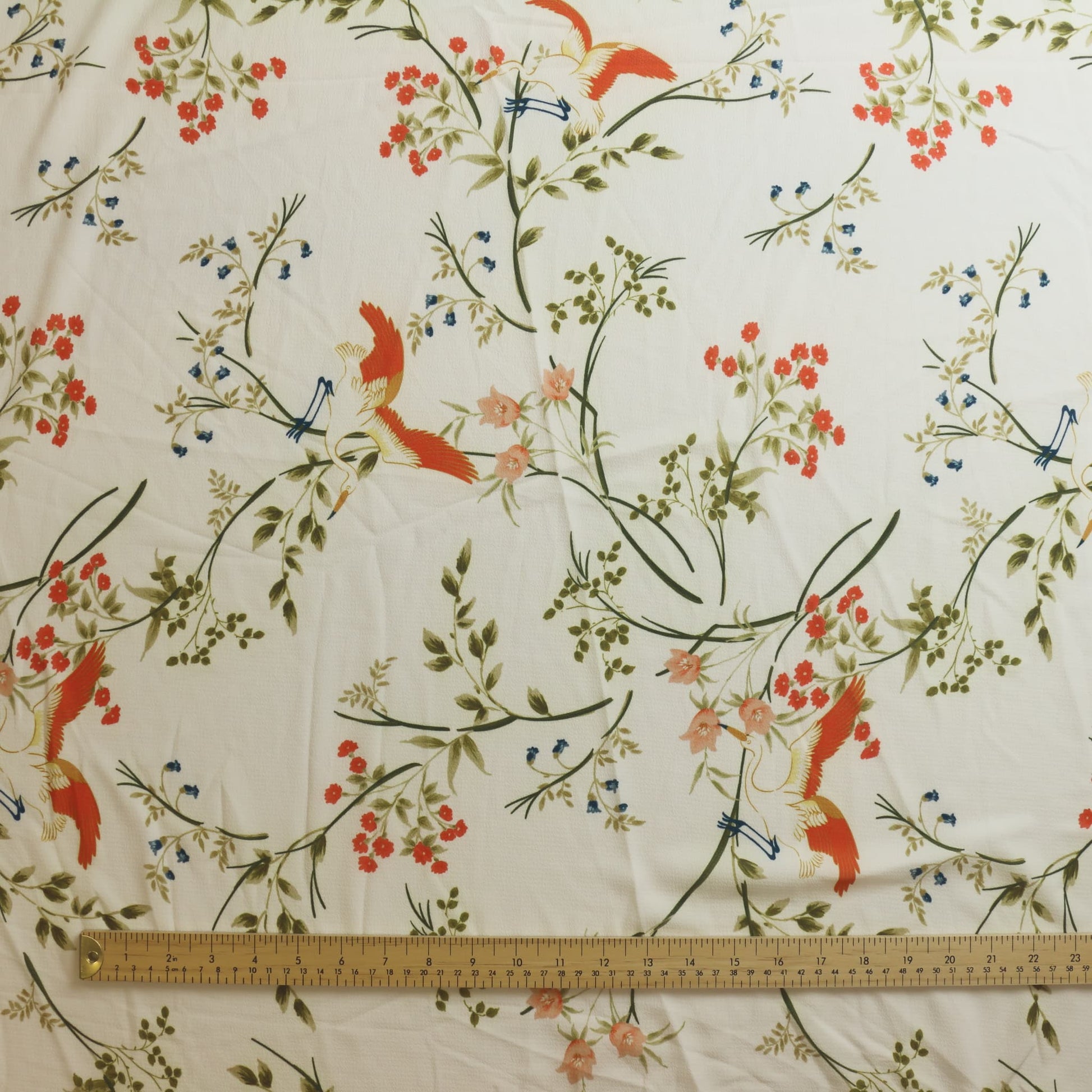 White floral crane print polyester sewing fabric laid flat