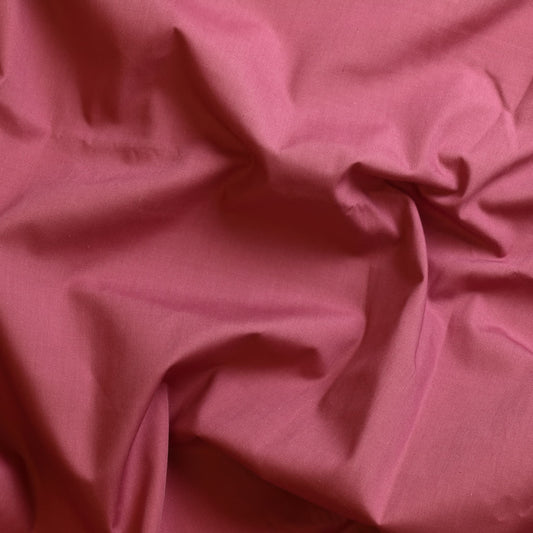 Dusky pink poly-cotton sewing fabric showing drape