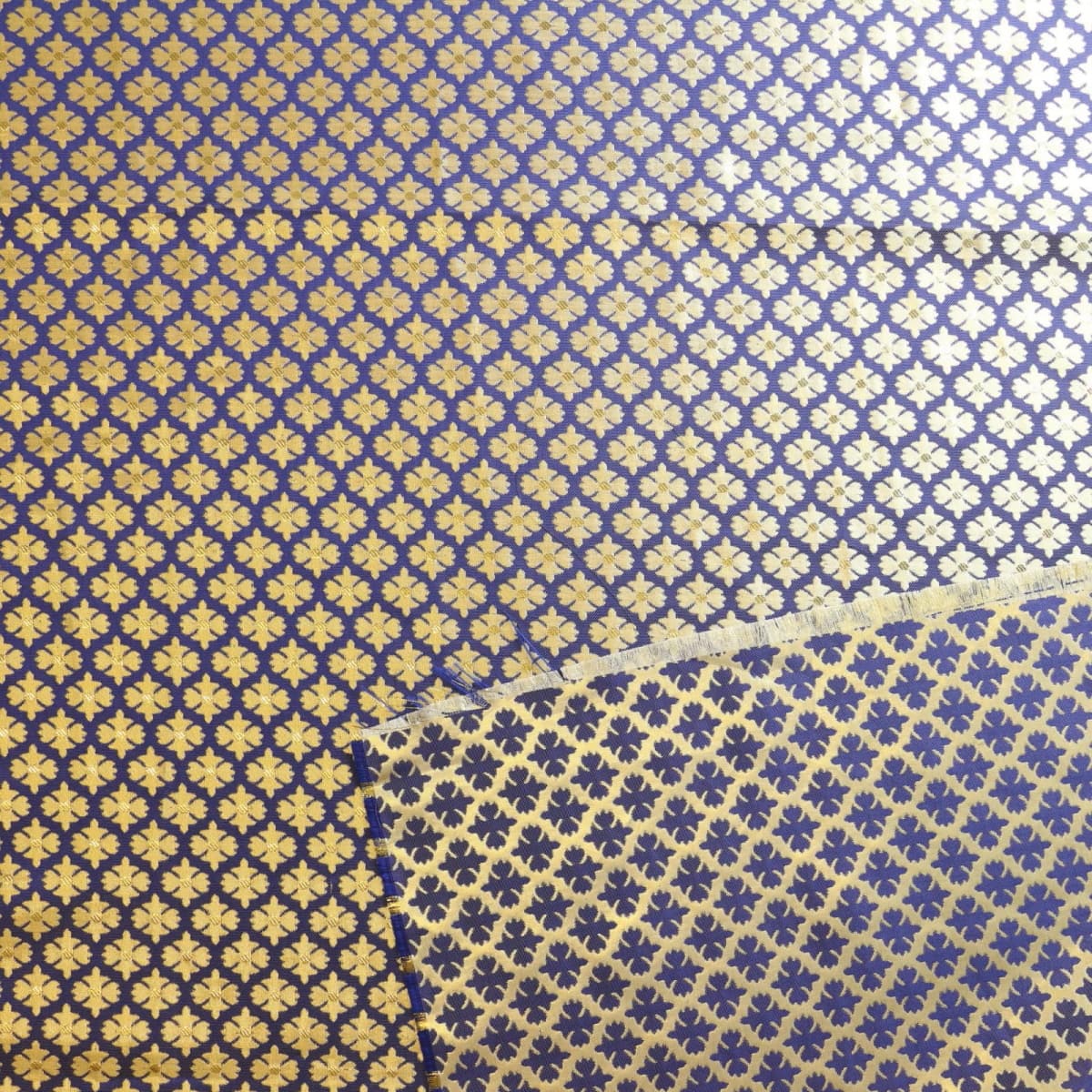 Blue & gold floral jacquard sewing fabric laid flat showing reverse detail
