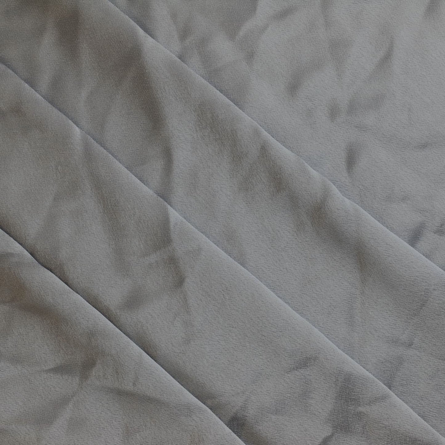 Steel gray polyester satin sewing fabric gently folded