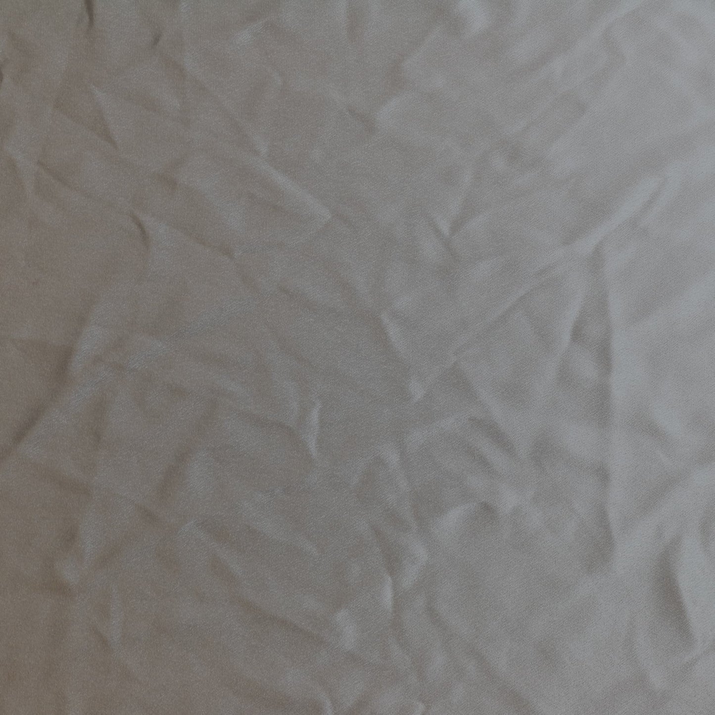 Steel gray polyester satin sewing fabric laid flat