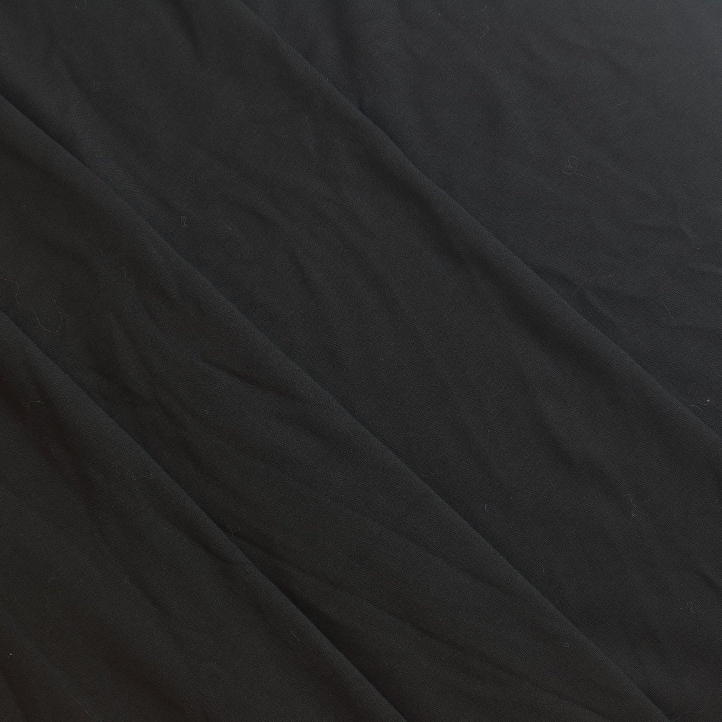 Off-white poly-cotton twill dressmaking or home decor fabric showing structure and drape