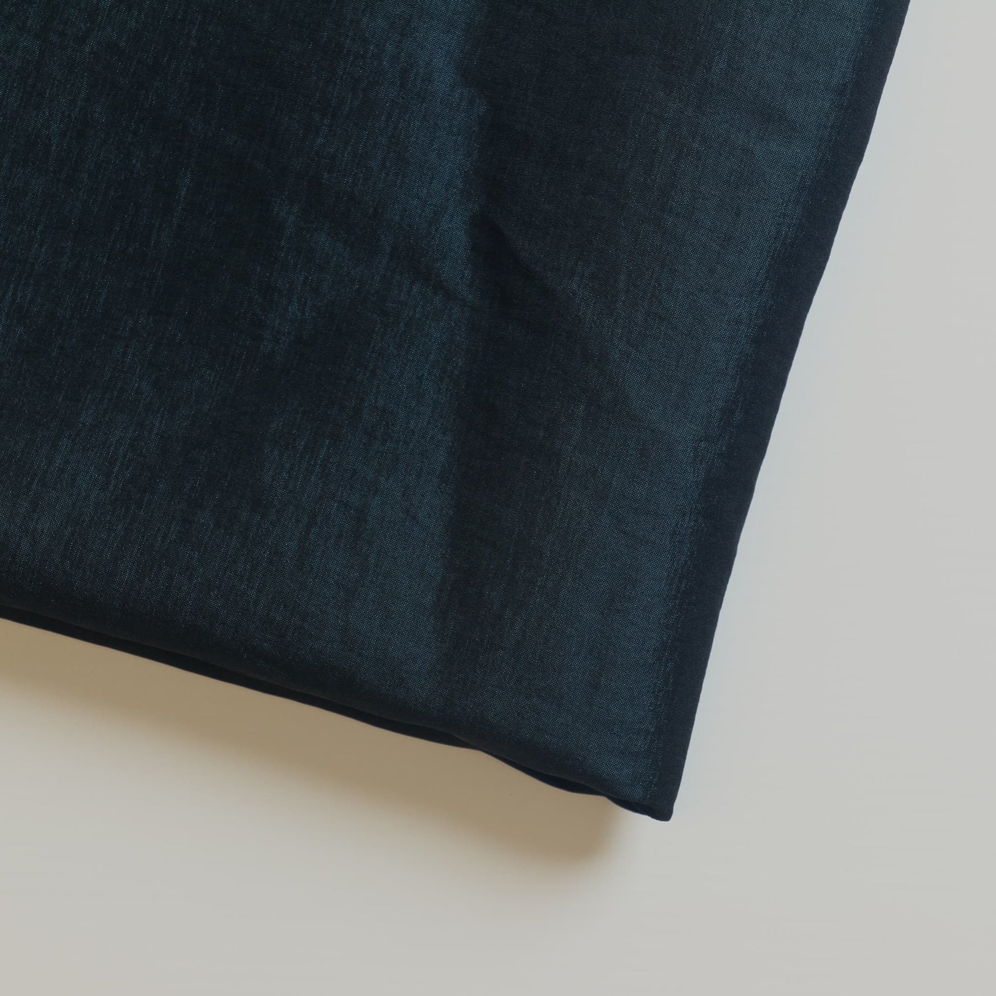 Dark teal stretch dupioni sewing fabric close up