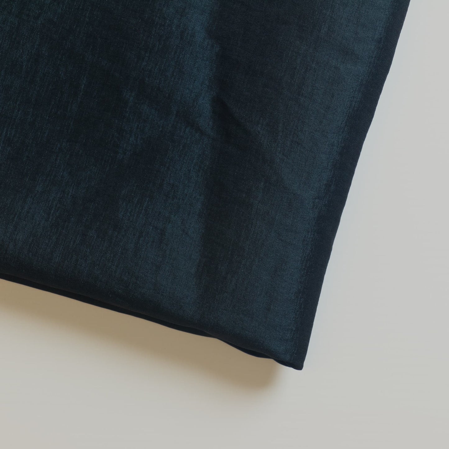 Off-white poly-cotton twill dressmaking or home decor fabric laid flat