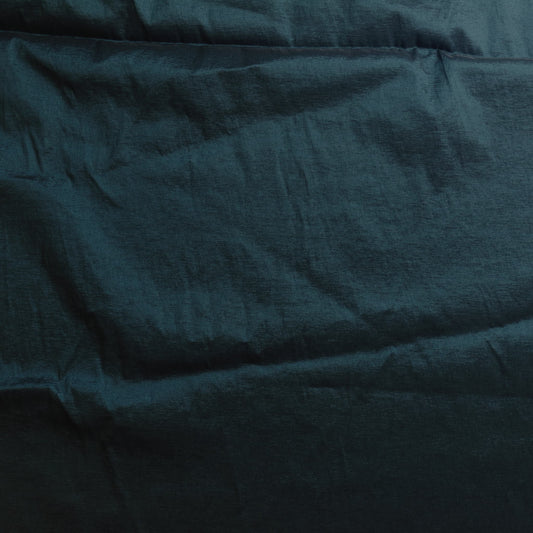 Dark teal stretch dupioni sewing fabric laid flat