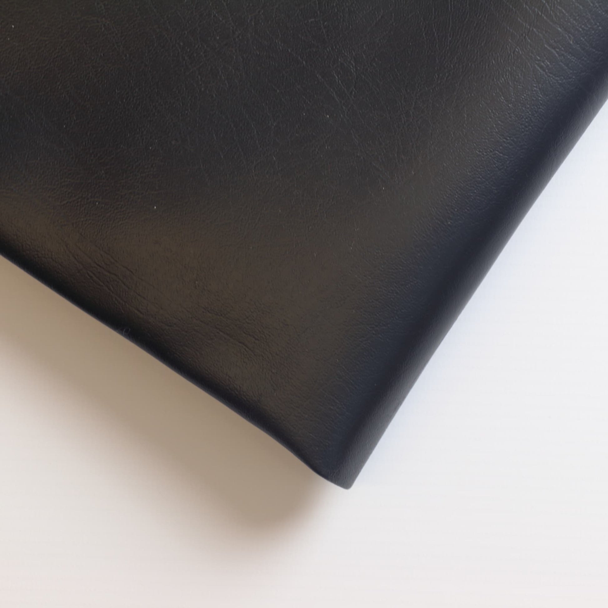 Black PU faux leather sewing fabric close up
