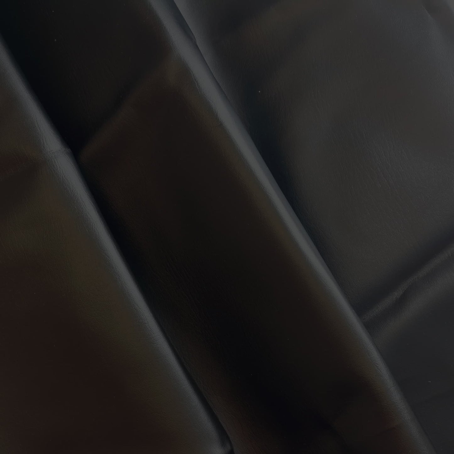 Black PU faux leather sewing fabric gently folded