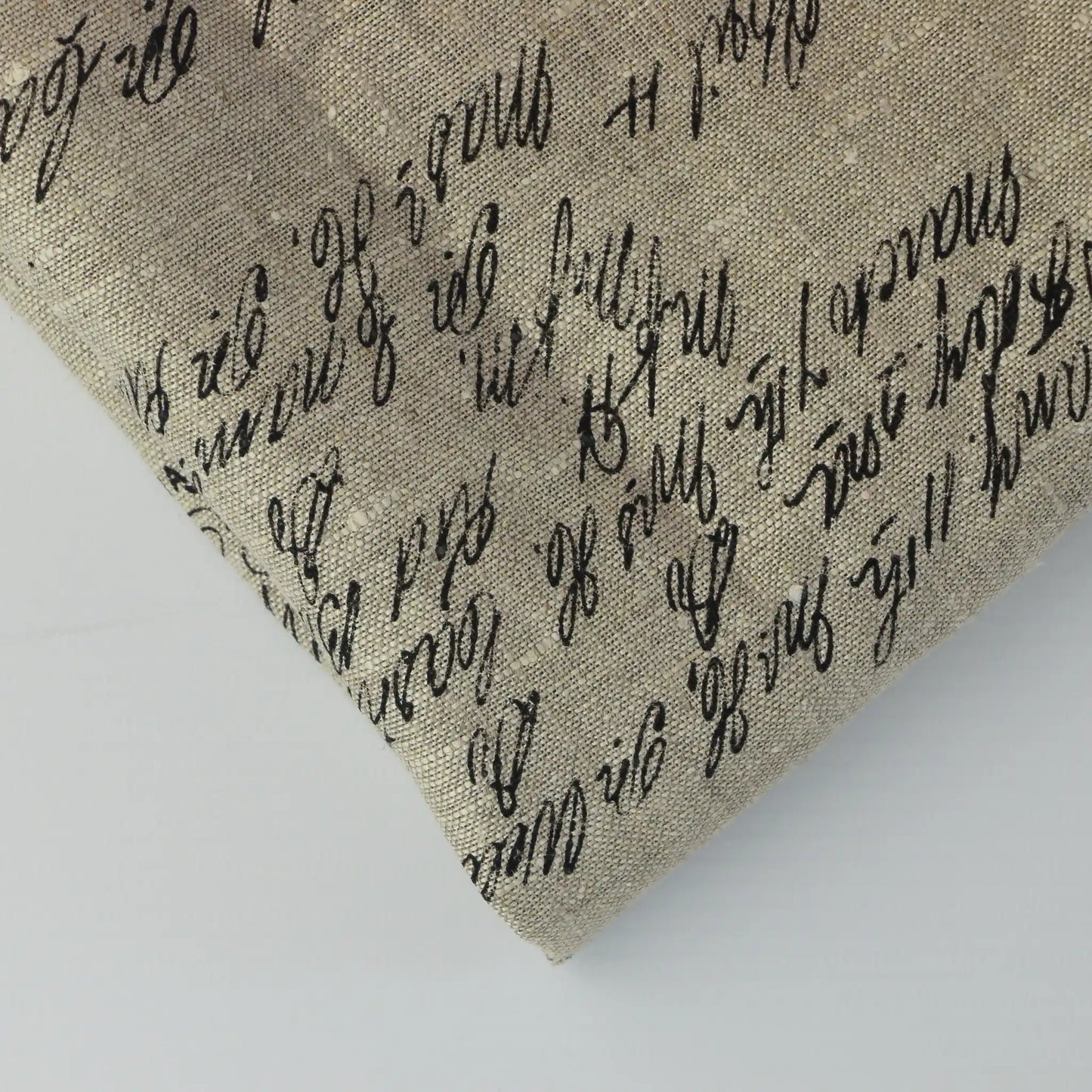 beige-script-print-linen-effect-home-decor-fabic-remnants – close-up of colour, pattern and texture