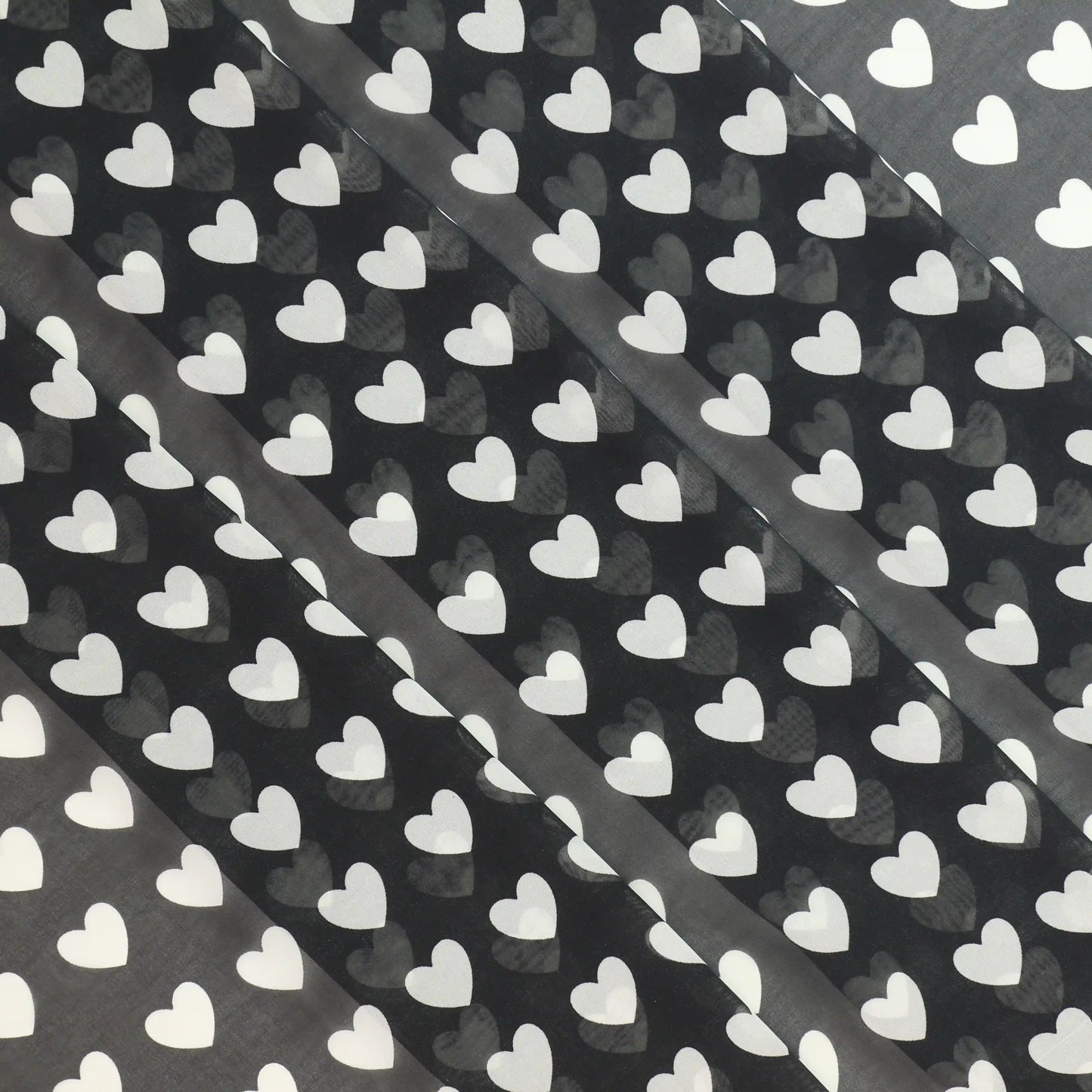 black-and-white-heart-print-chiffon-fabric – product laid flat showing its colour and pattern