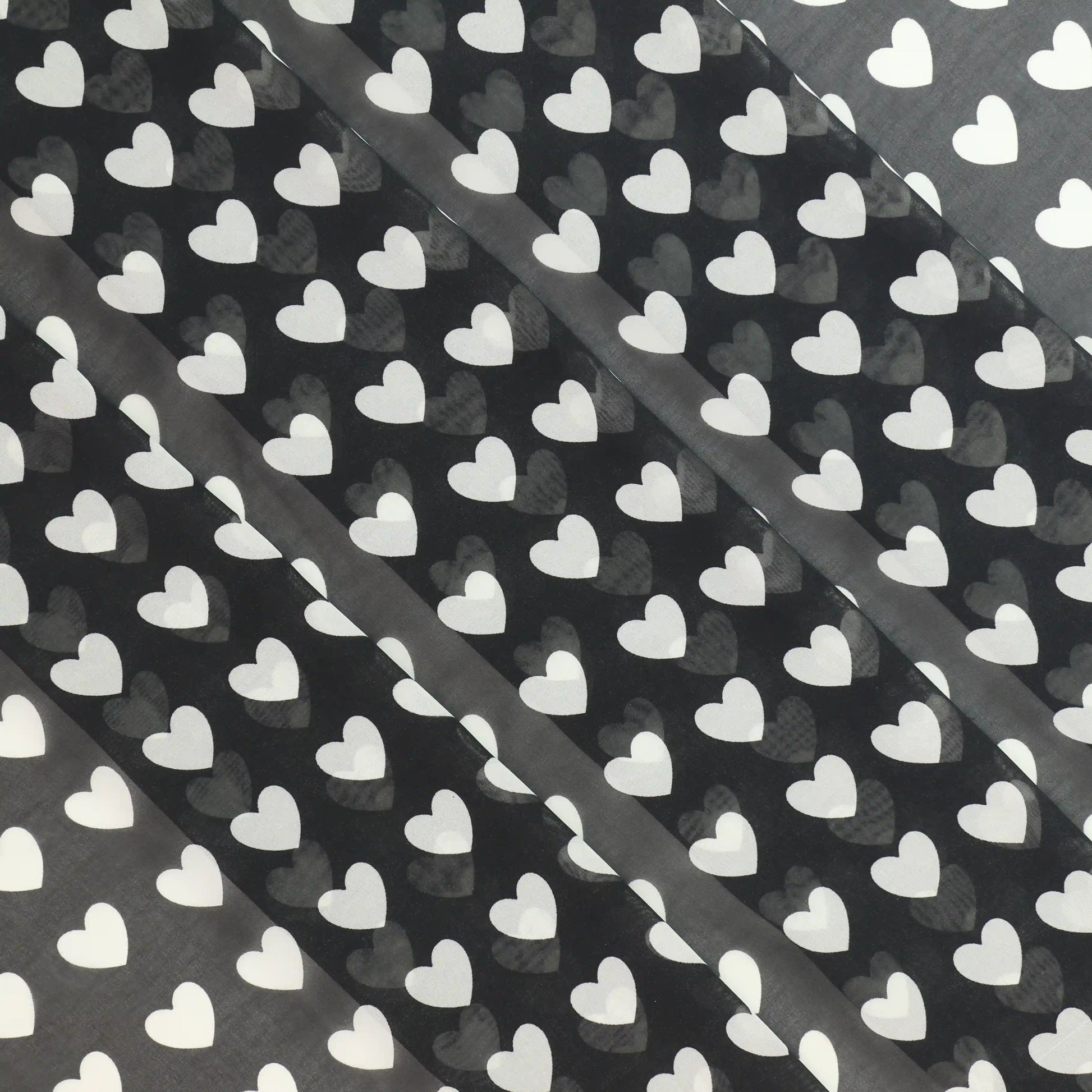 black-and-white-heart-print-chiffon-fabric – product laid flat showing its colour and pattern