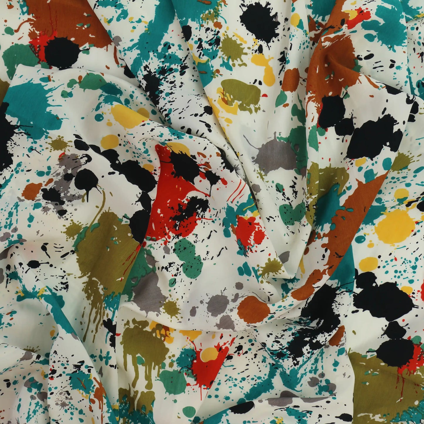 paint-splatter-polyester-peach-skin-fabric – product laid flat showing its colour and pattern