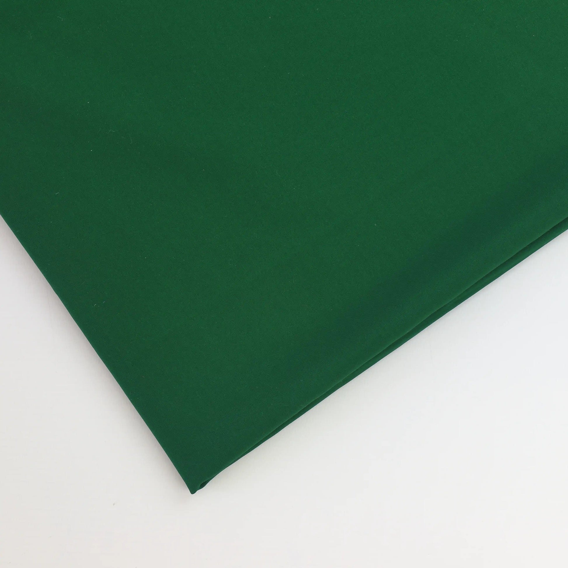 green-polyester-faux-silk-fabric – close-up of colour, pattern and texture